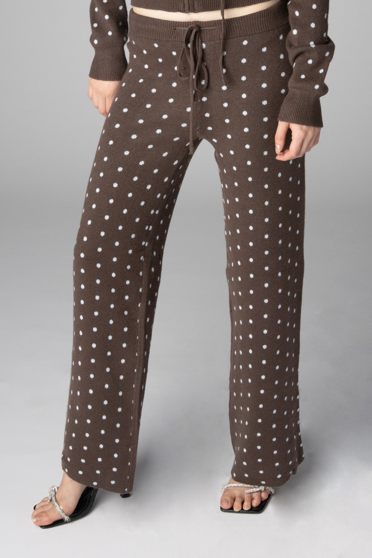 Brown knit wide-leg lounge pants featuring a white polka dot pattern and drawstring waist