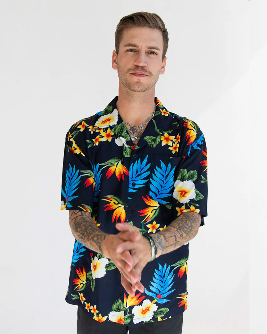 Model wearing a vibrant tropical theme Hawaiian Shirt