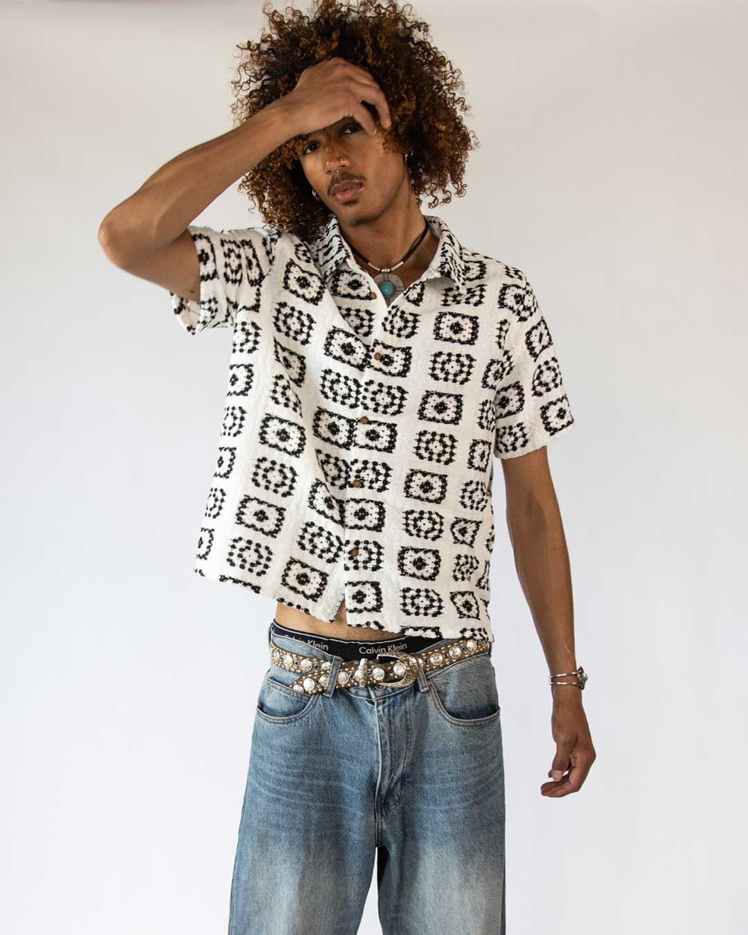 male model wearing a woven black and white button up shirt