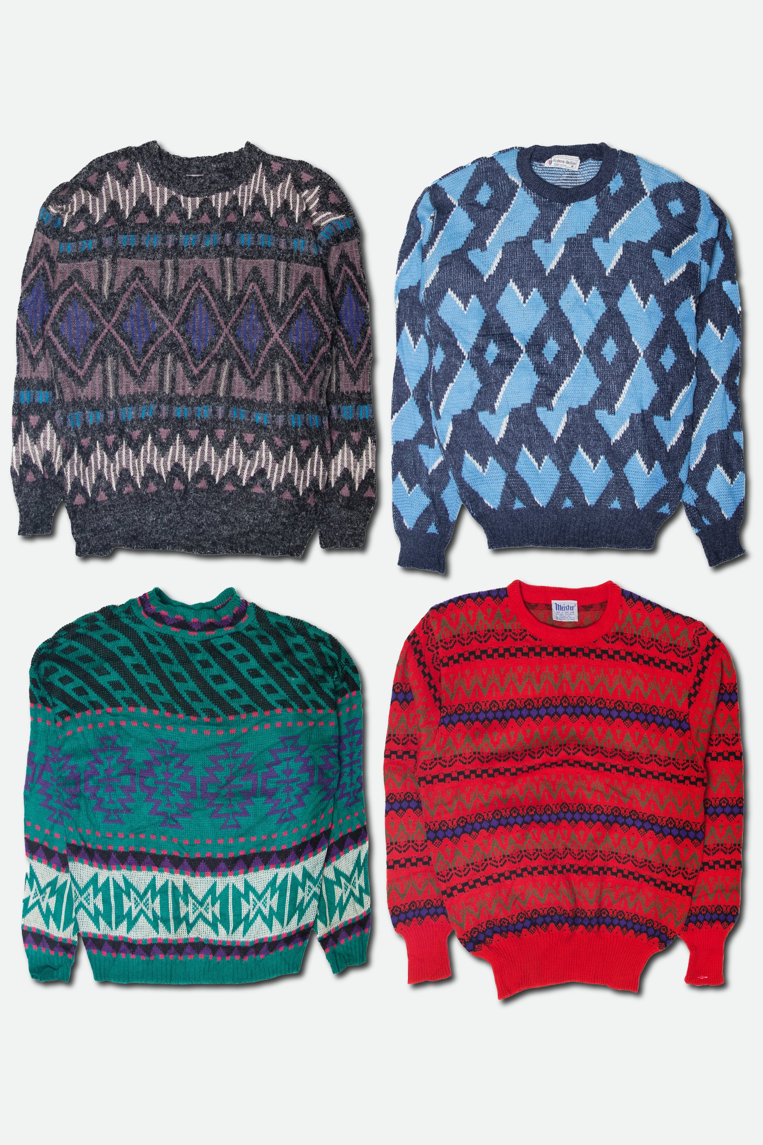Four patterned sweaters in different colors on a white background