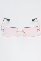 Rimless rectangle sunglasses with pink gradient lenses and gold-tone temples, providing UV protection and one size fits most.