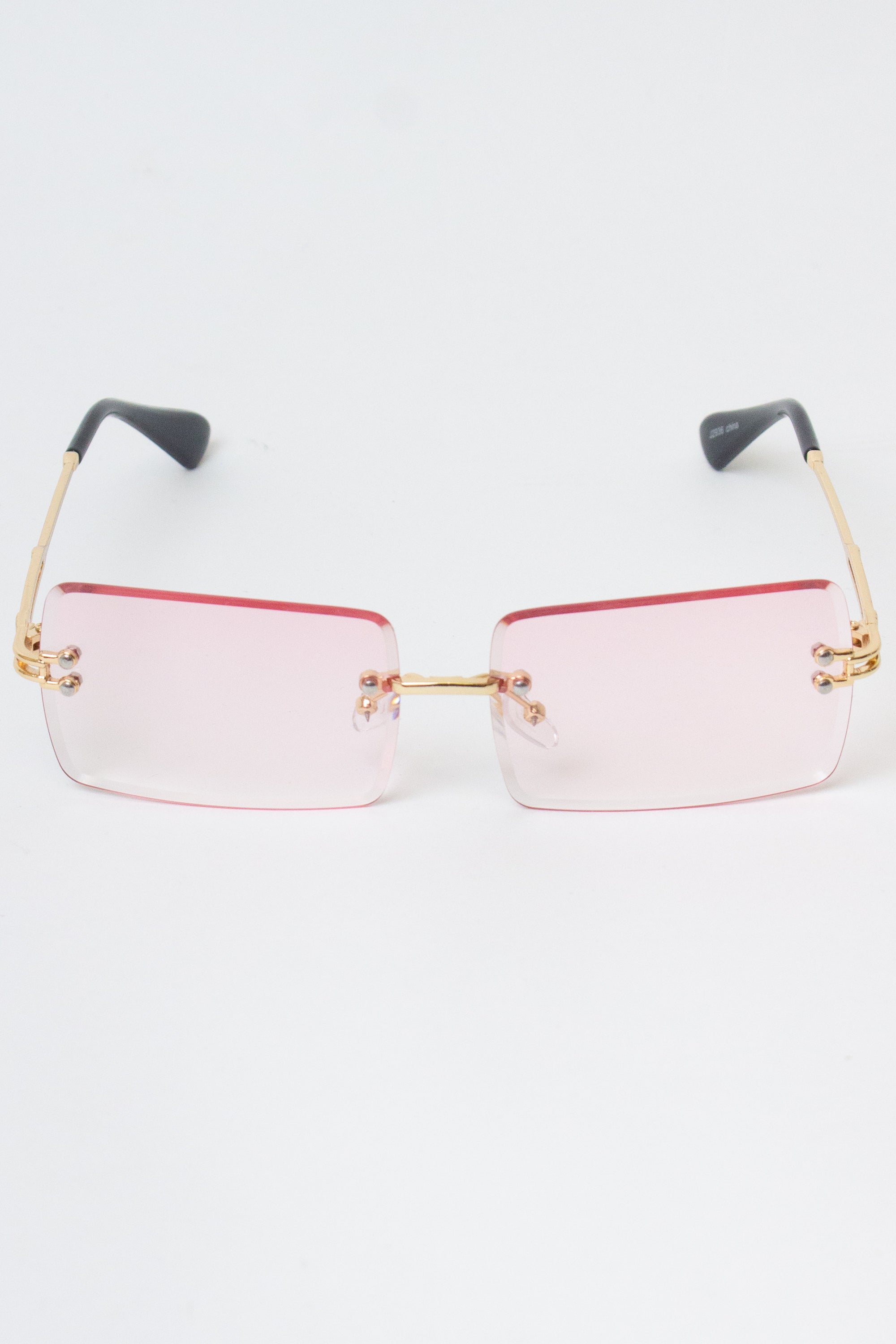 Rimless rectangle sunglasses with pink gradient lenses and gold-tone temples, providing UV protection and one size fits most.