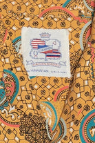 Patterned fabric with a Kahanamoku label on an orange background