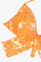 Bright orange sequin butterfly-shaped halter crop top detail