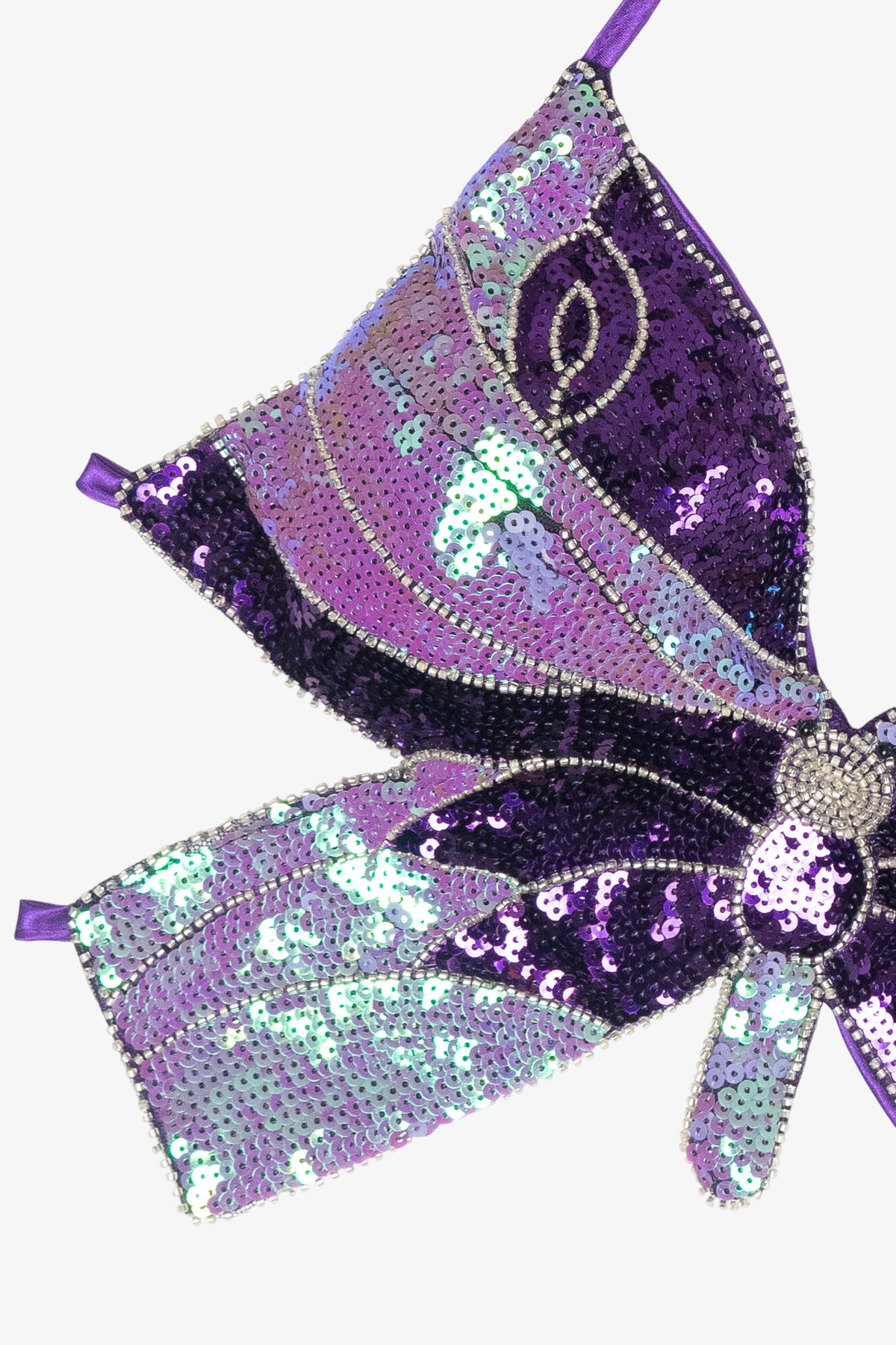 Detail of a purple butterfly top embellished with shimmering sequins and beads