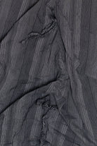 Close-up of black fabric with thin white pinstripes and gathered details from Polli Says pinstripe balloon skirt