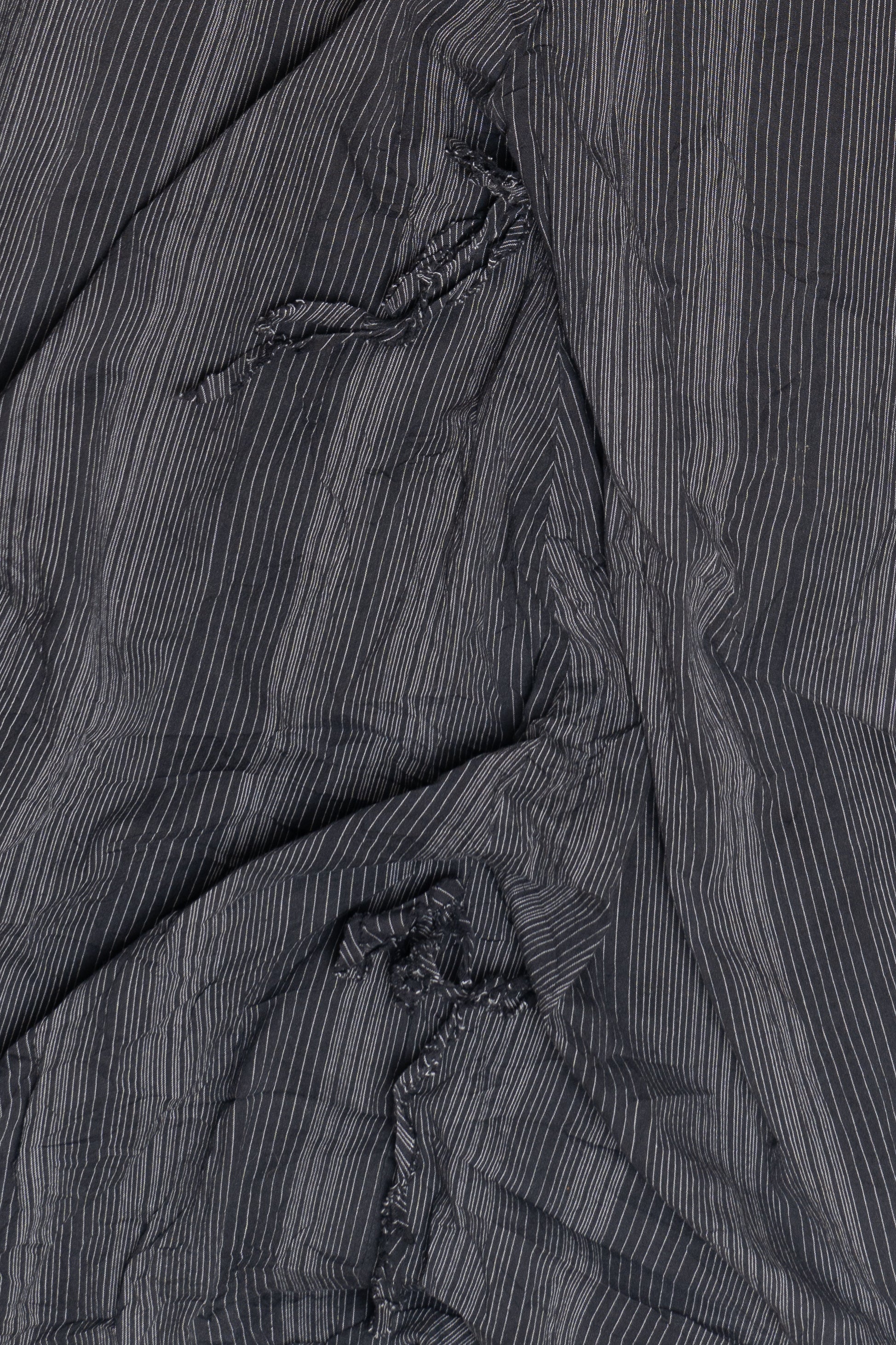 Close-up of black fabric with thin white pinstripes and gathered details from Polli Says pinstripe balloon skirt