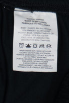 Nike Dri-FIT San Francisco Embroidered Track Pants fabric tag with care instructions and material details visible