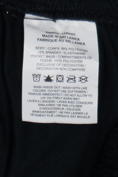 Nike Dri-FIT San Francisco Embroidered Track Pants fabric tag with care instructions and material details visible