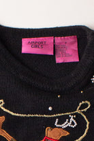Close-up of kids black ugly Christmas pullover label and embroidered festive reindeer design