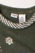 Close-up of kids green ugly Christmas pullover with snowflake embroidery and clothing labels inside collar