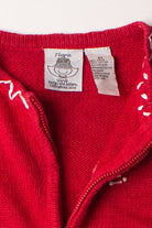 Close-up of red kids cardigan neck and label showing size 6X and cotton material on Christmas sweater