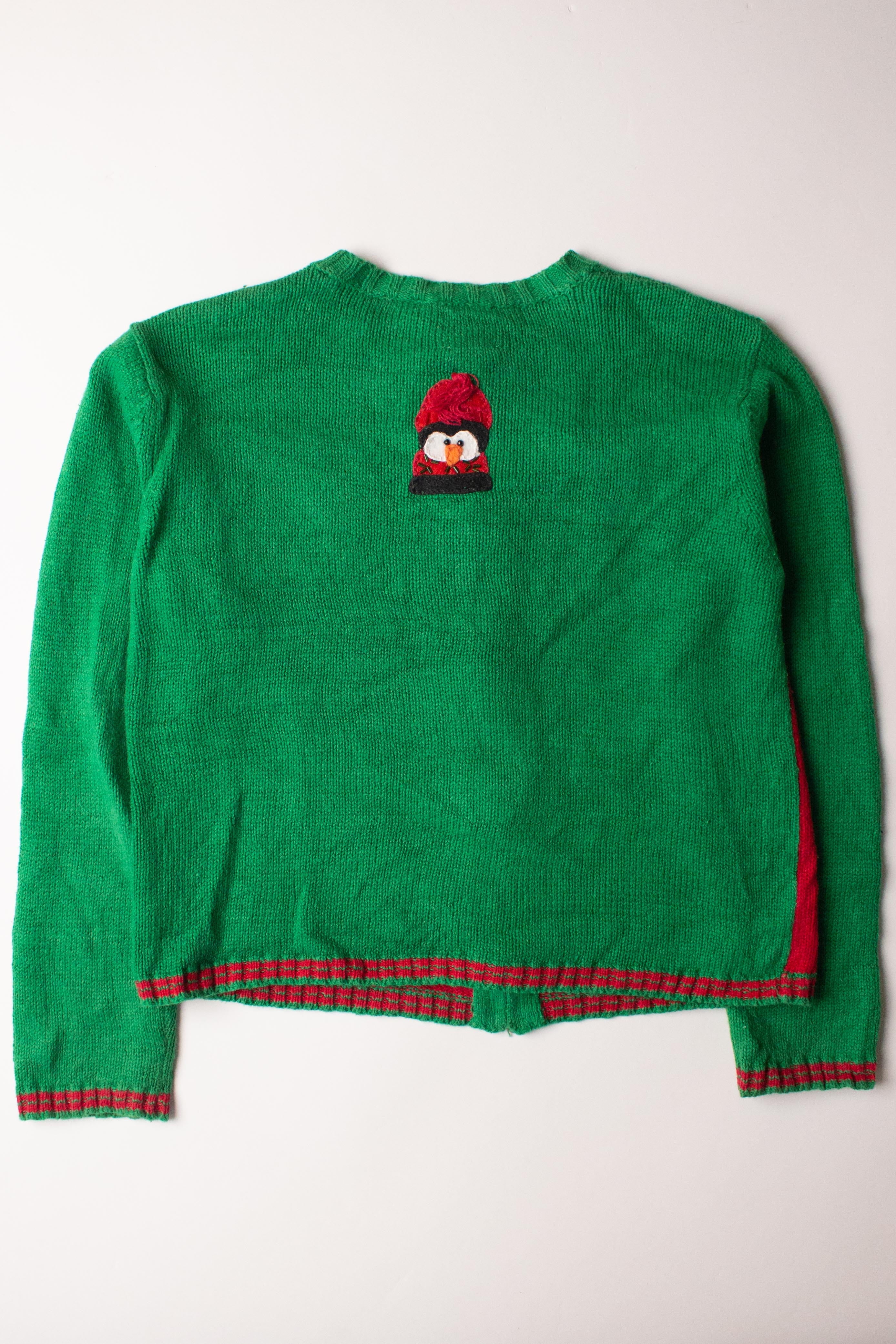 Kids green Christmas cardigan with red trim and a small penguin wearing a red hat embroidered on back
